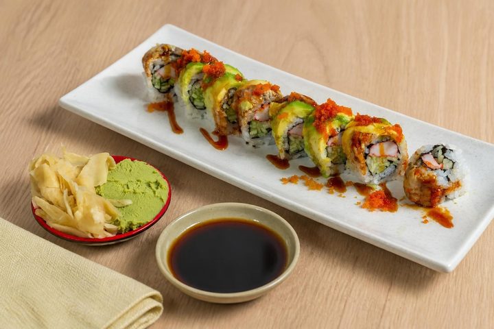 An avocado-topped special roll with eel sauce