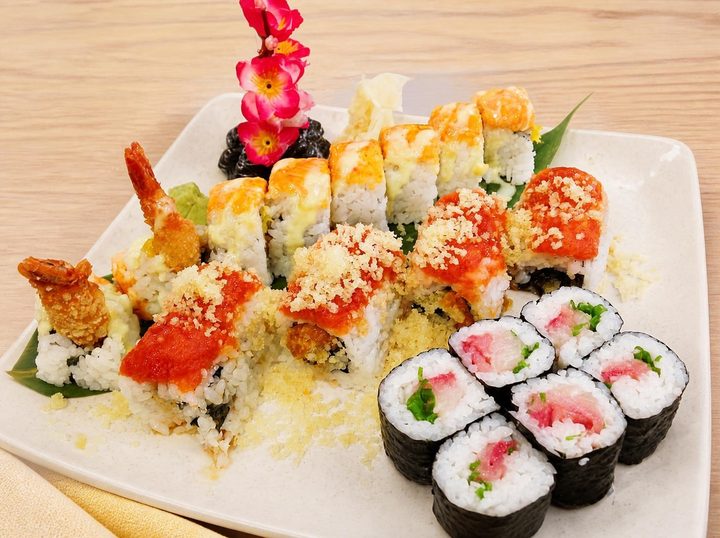 A large platter of sushi rolls and maki
