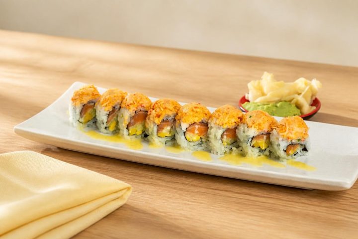 A roll topped with spicy crab